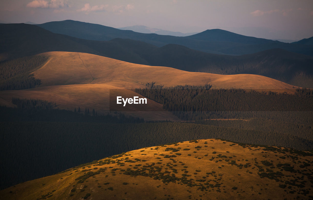 Scenic view of mountains against sky during sunset