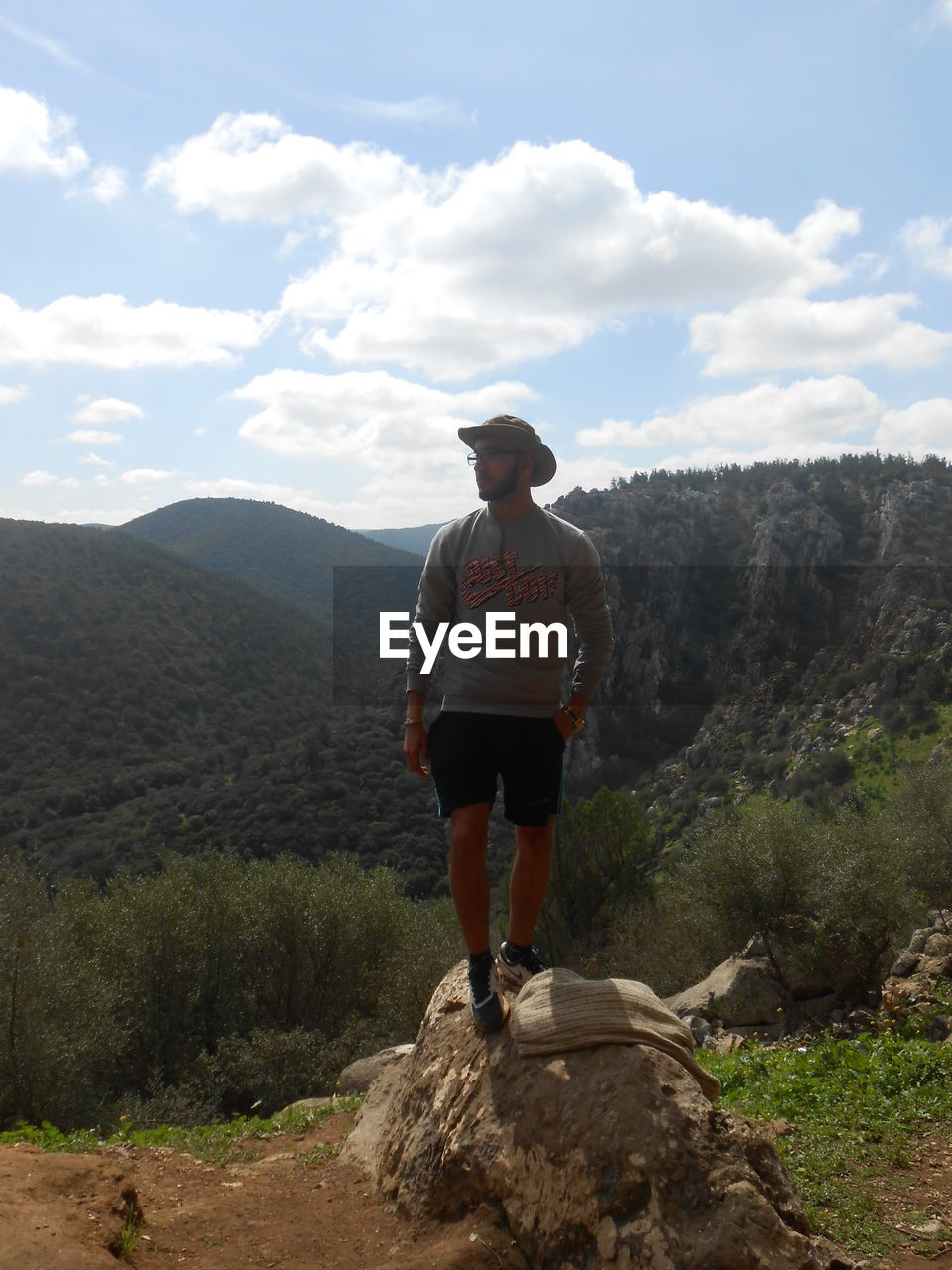 Man standing on rock against mountain