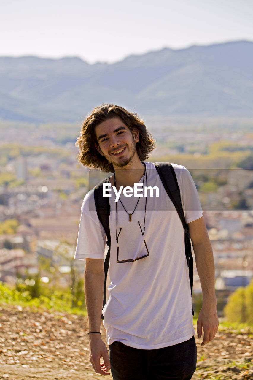 Portrait of smiling male hiker during sunny day