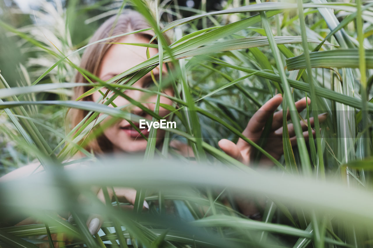 Young woman amidst grass