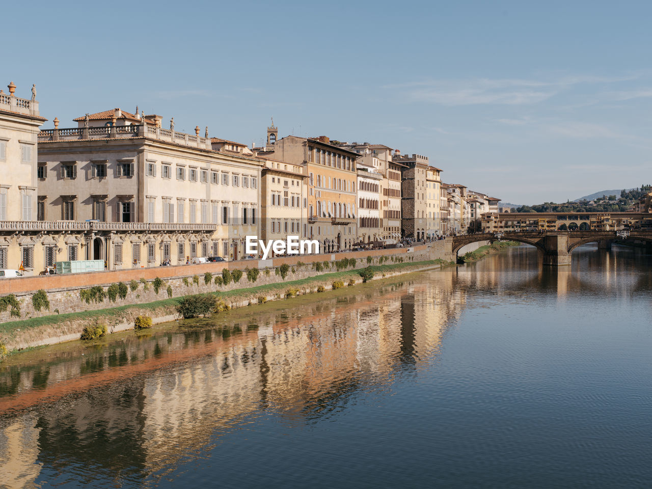 Florence in fall with reflection of buildings in the arno river