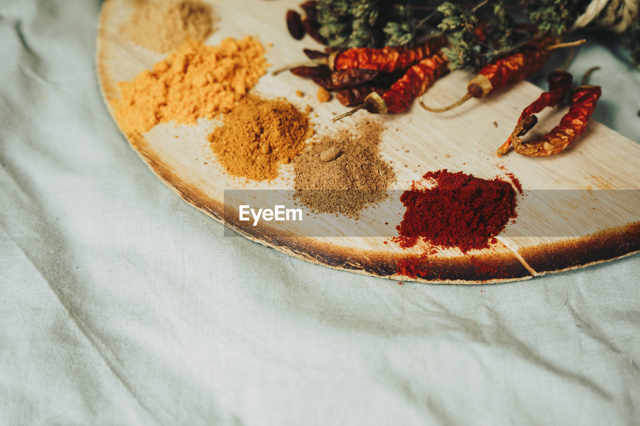 Spices and red chili peppers on table