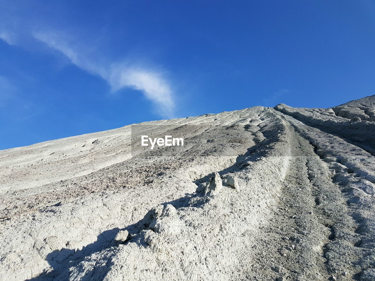 Low angle view of rocky mountain against sky