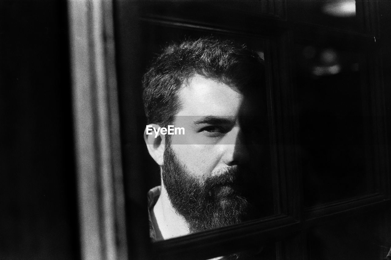 Close-up of portrait of young man reflecting on mirror