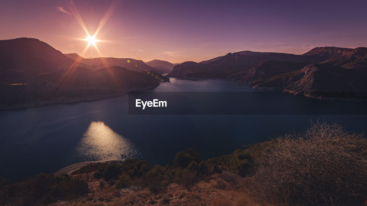 Scenic view of lake against sky during sunset