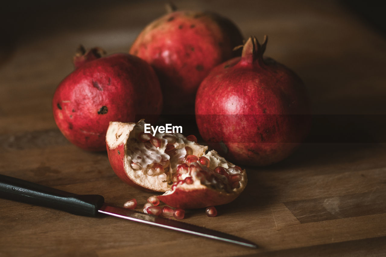 CLOSE-UP OF APPLES IN CONTAINER ON TABLE