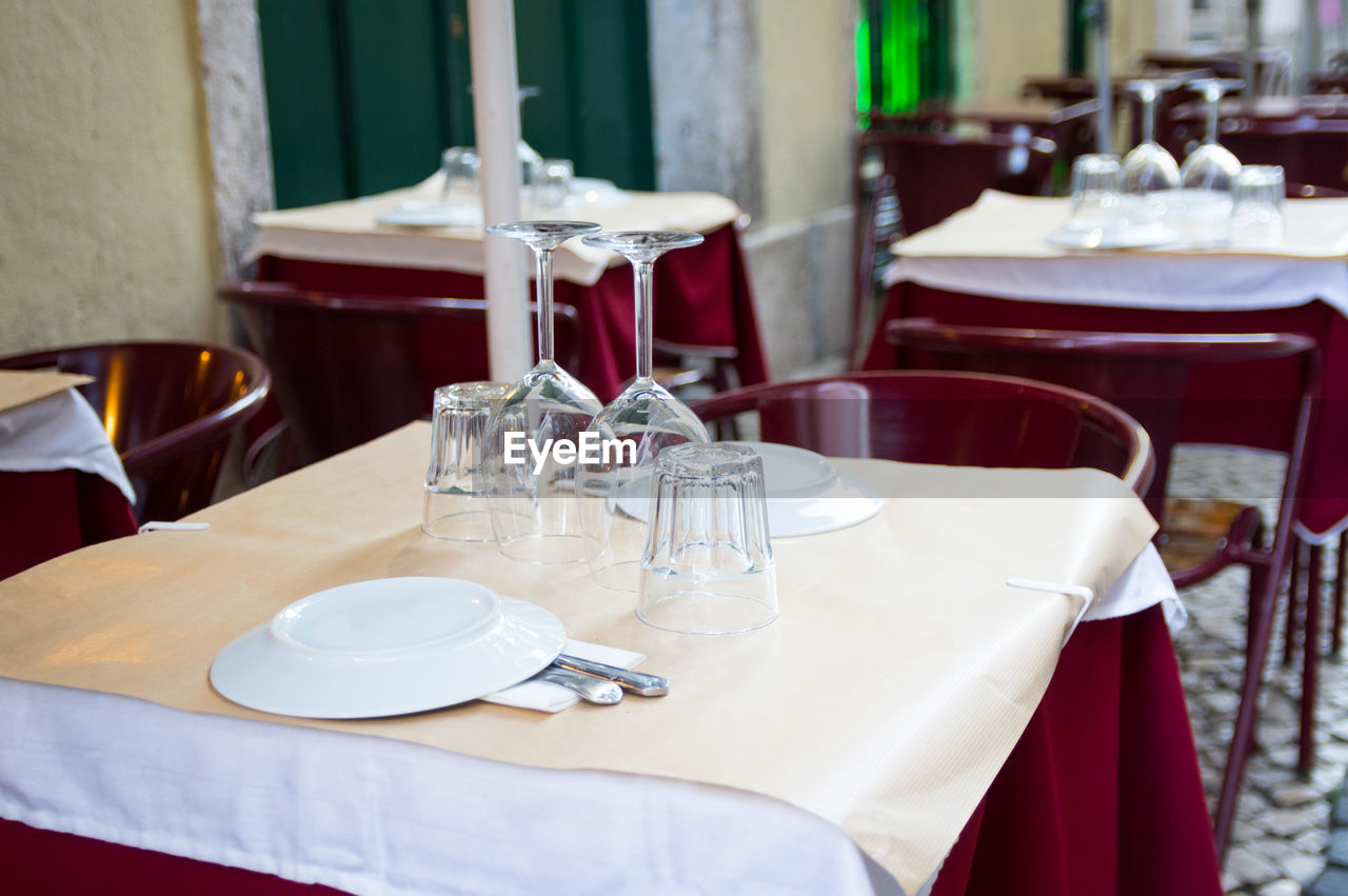 Empty chairs and tables on table at restaurant