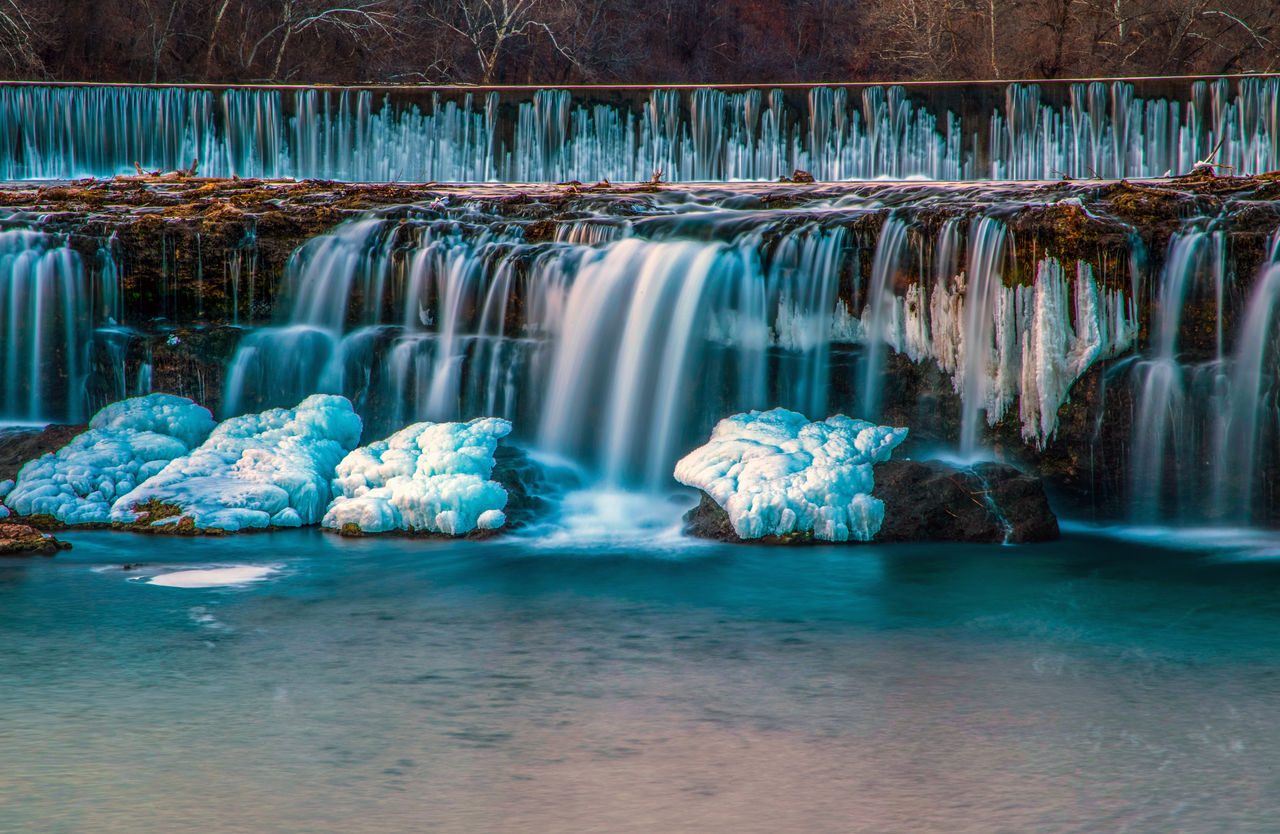 waterfall, water, scenics - nature, beauty in nature, nature, water feature, environment, ice, cold temperature, no people, landscape, reflection, travel destinations, travel, rock, blue, body of water, outdoors, tourism, sea, long exposure, land, winter, frozen