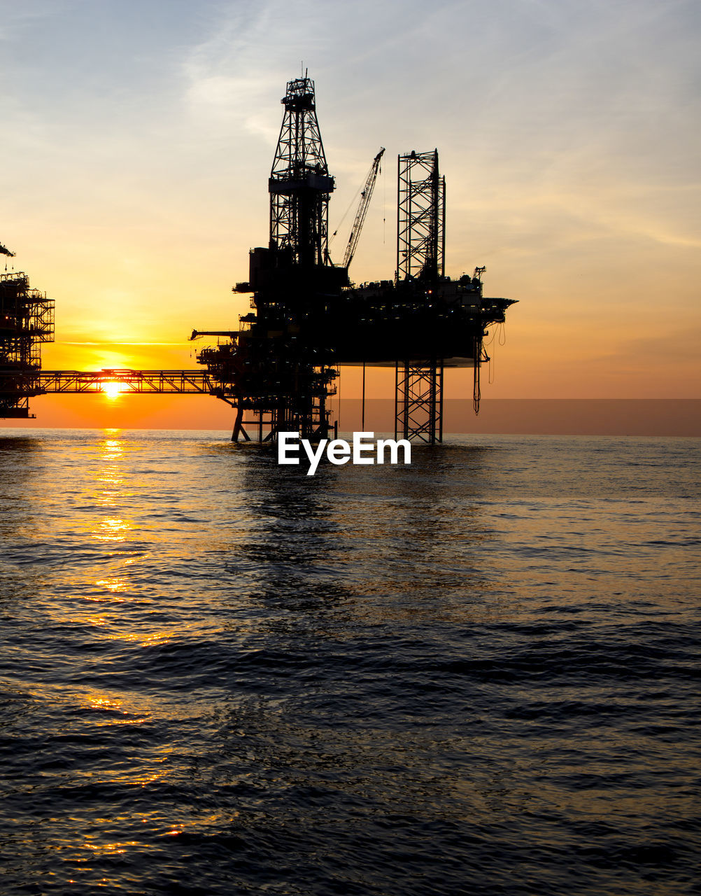 Offshore gas production platform at sunset