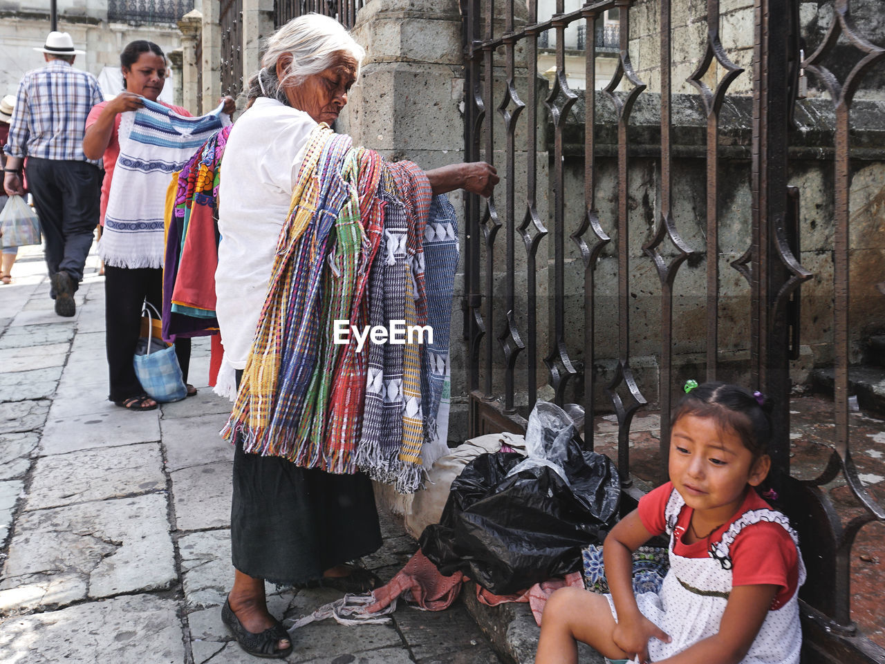 REAR VIEW OF PEOPLE ON STREET