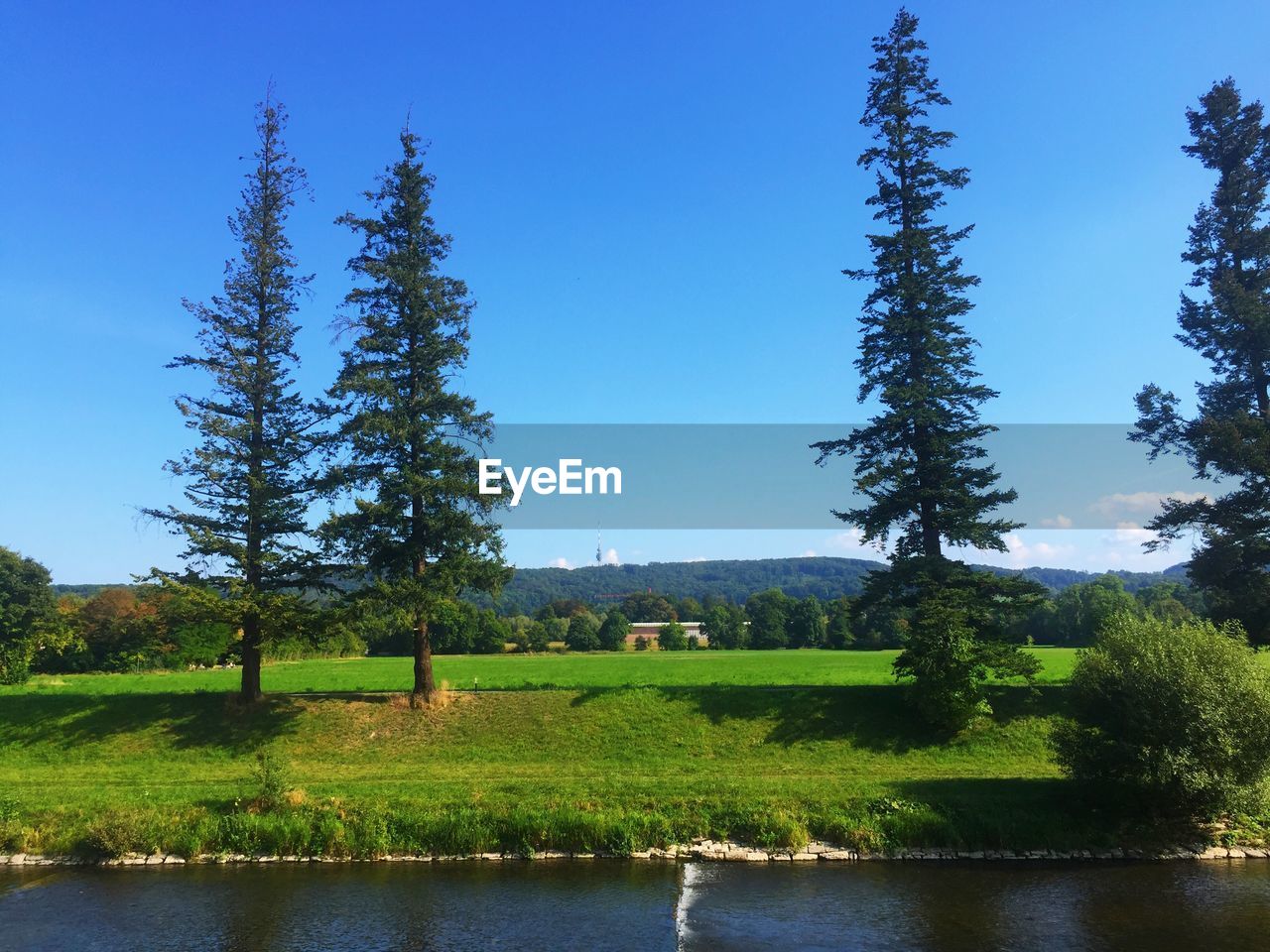 Scenic view of lake against clear blue sky