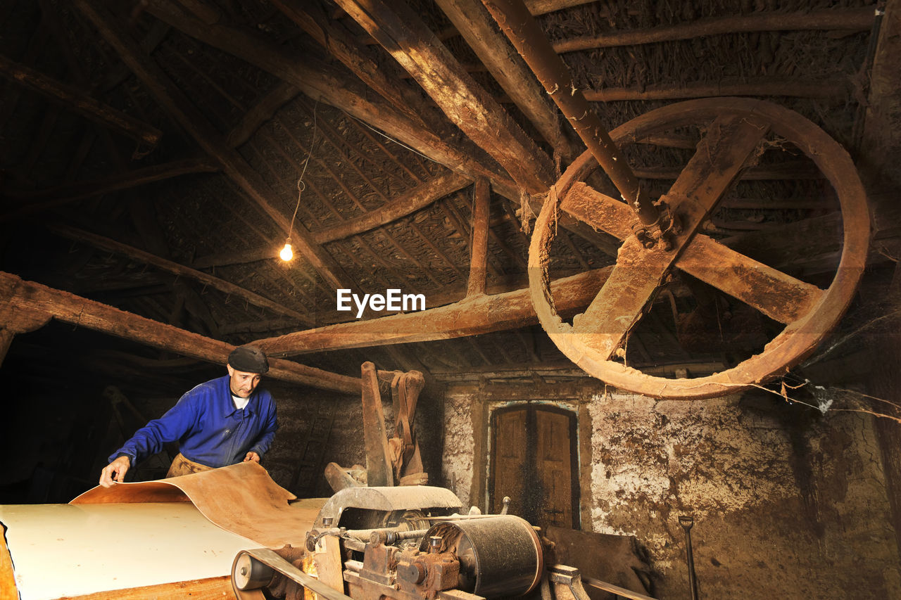 Man making leather in workshop