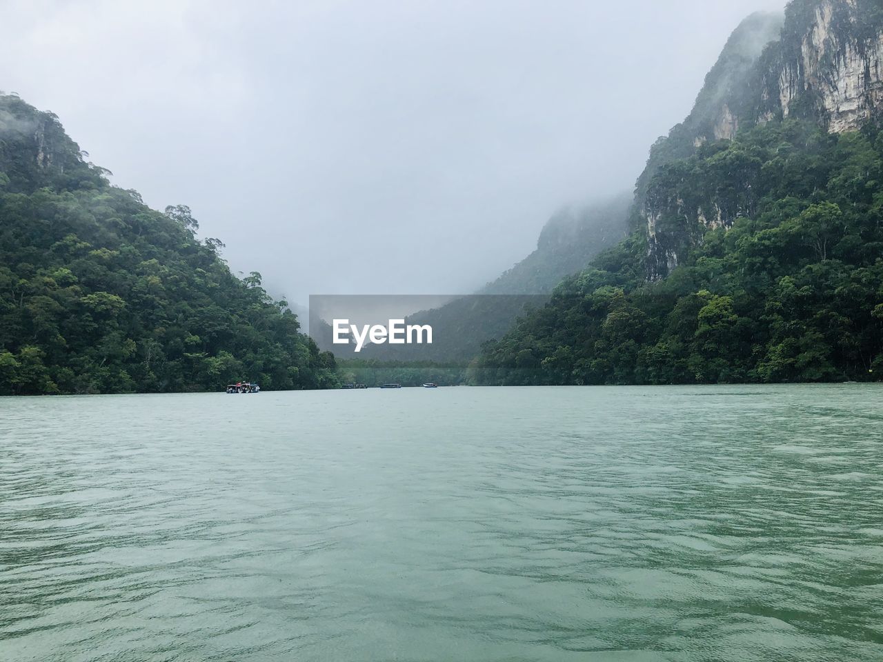 Scenic view of sea and mountains against sky