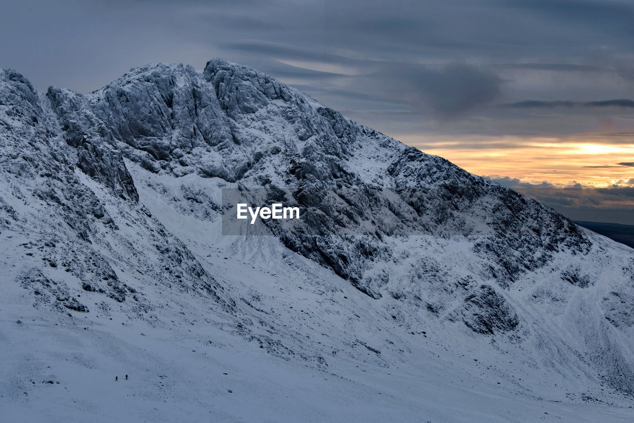 Scafell crag in winter with 2 tiny people