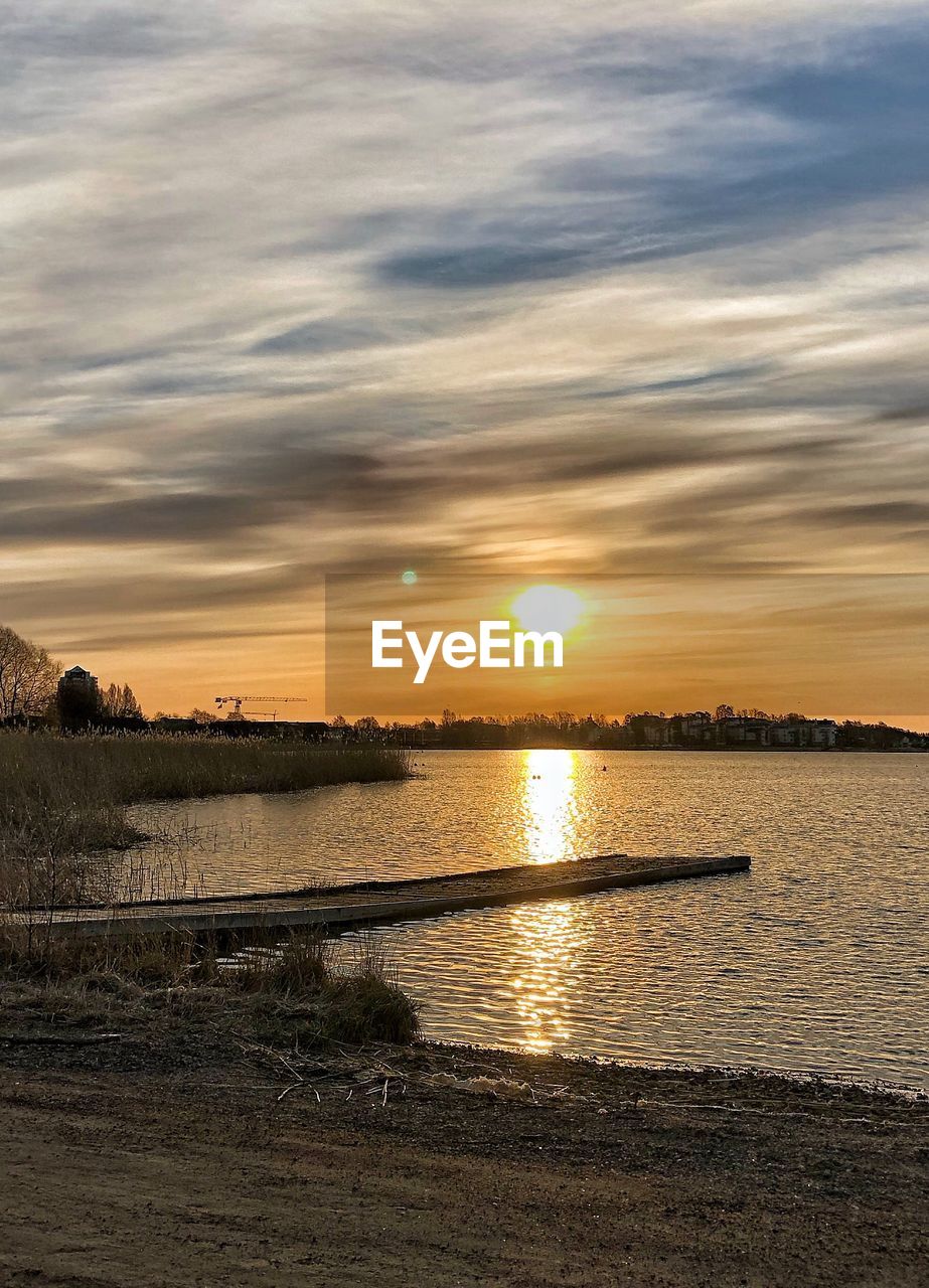 SCENIC VIEW OF SUNSET OVER WATER