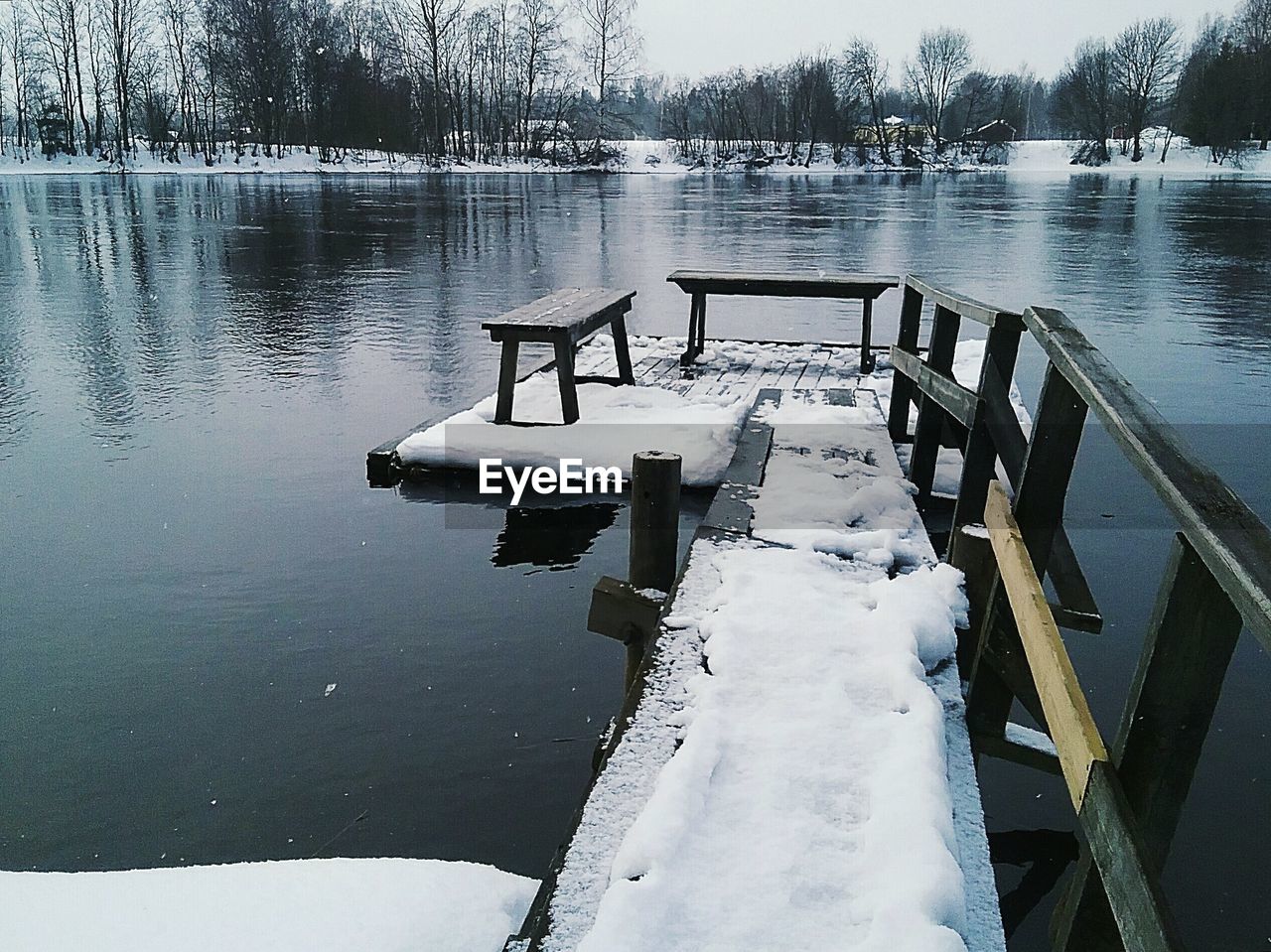 Snow on pier over river