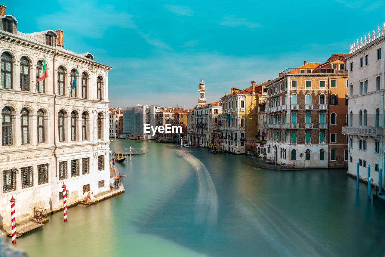 Canal amidst buildings in city