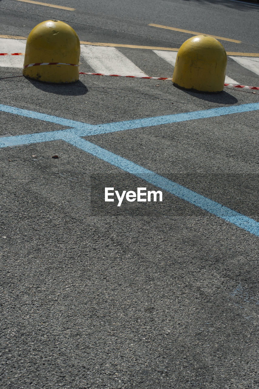 YELLOW UMBRELLA ON ROAD ALONG SIDE