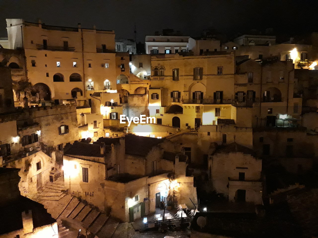 HIGH ANGLE VIEW OF ILLUMINATED BUILDINGS IN CITY