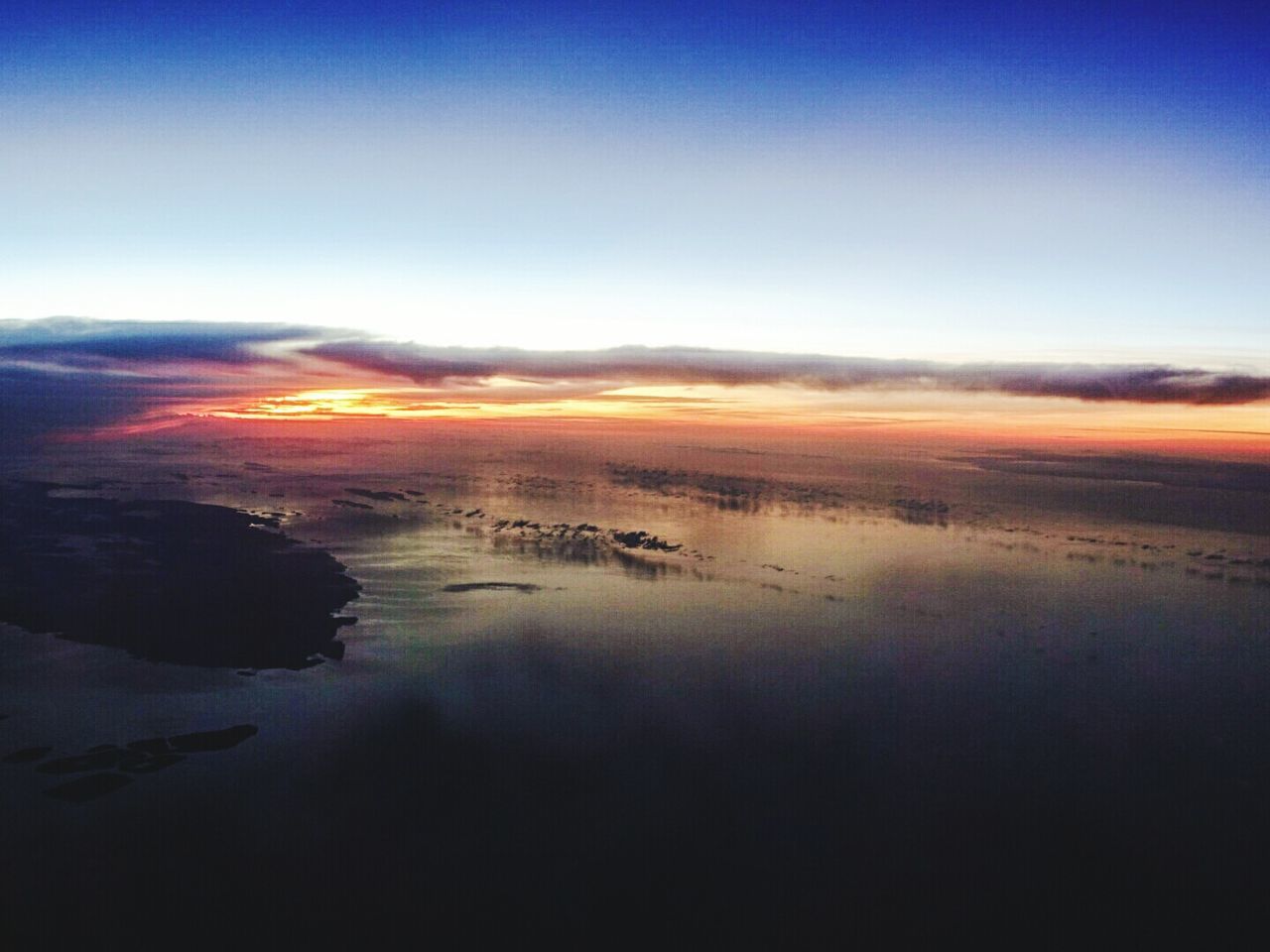 AERIAL VIEW OF LANDSCAPE AGAINST SKY DURING SUNSET