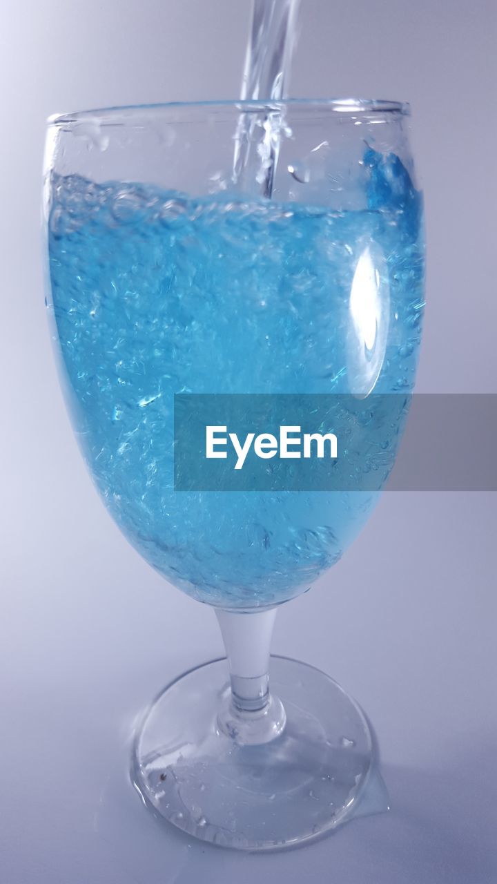 Close-up of blue drink in wineglass
