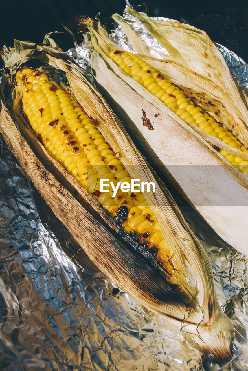 High angle view of corns on foil paper