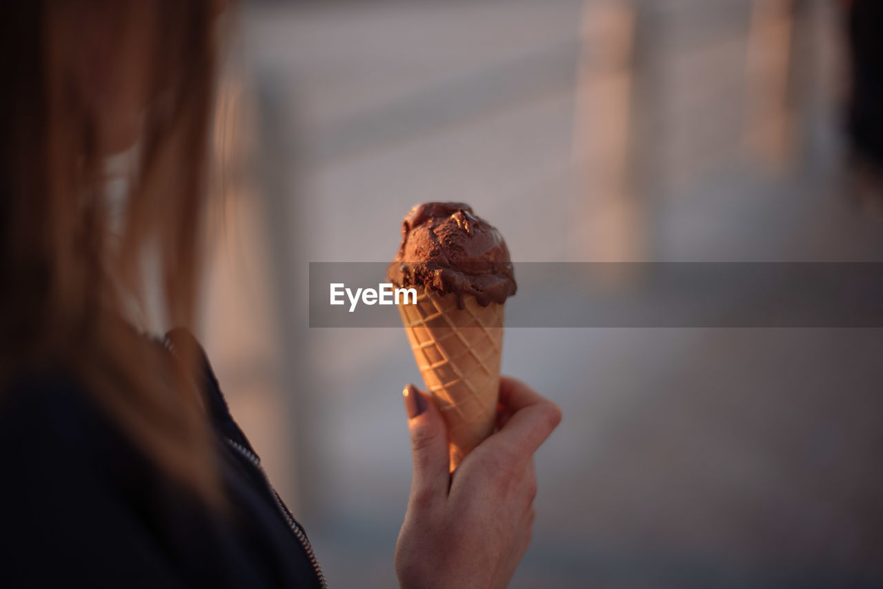 Cropped image of woman holding chocolate ice cream