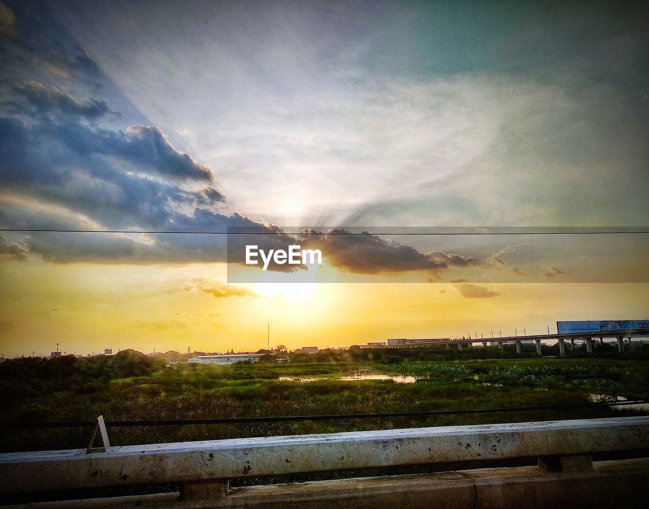 SCENIC VIEW OF SUNSET OVER FIELD