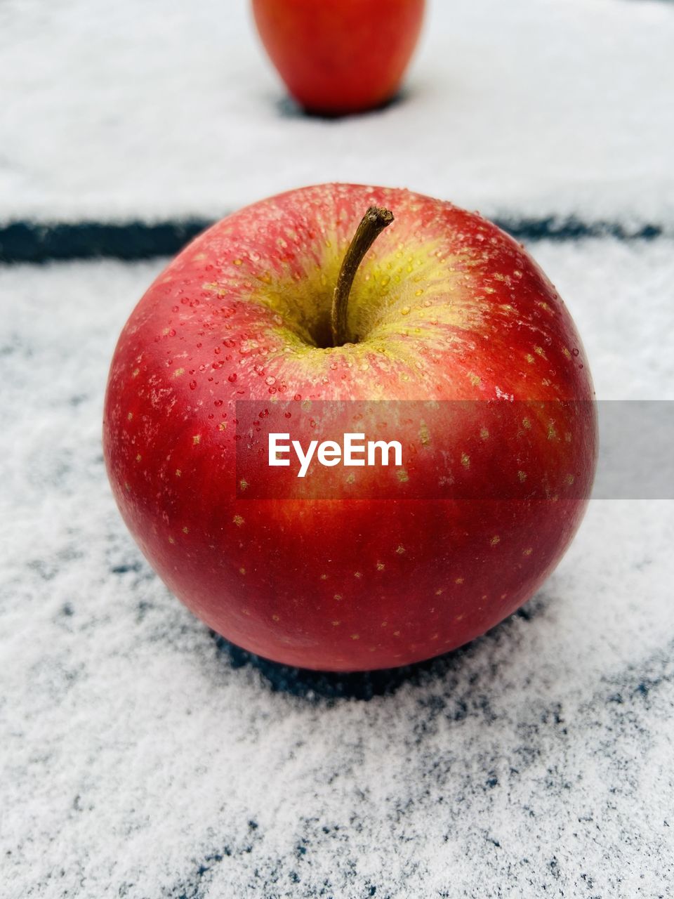 Apple on snow background