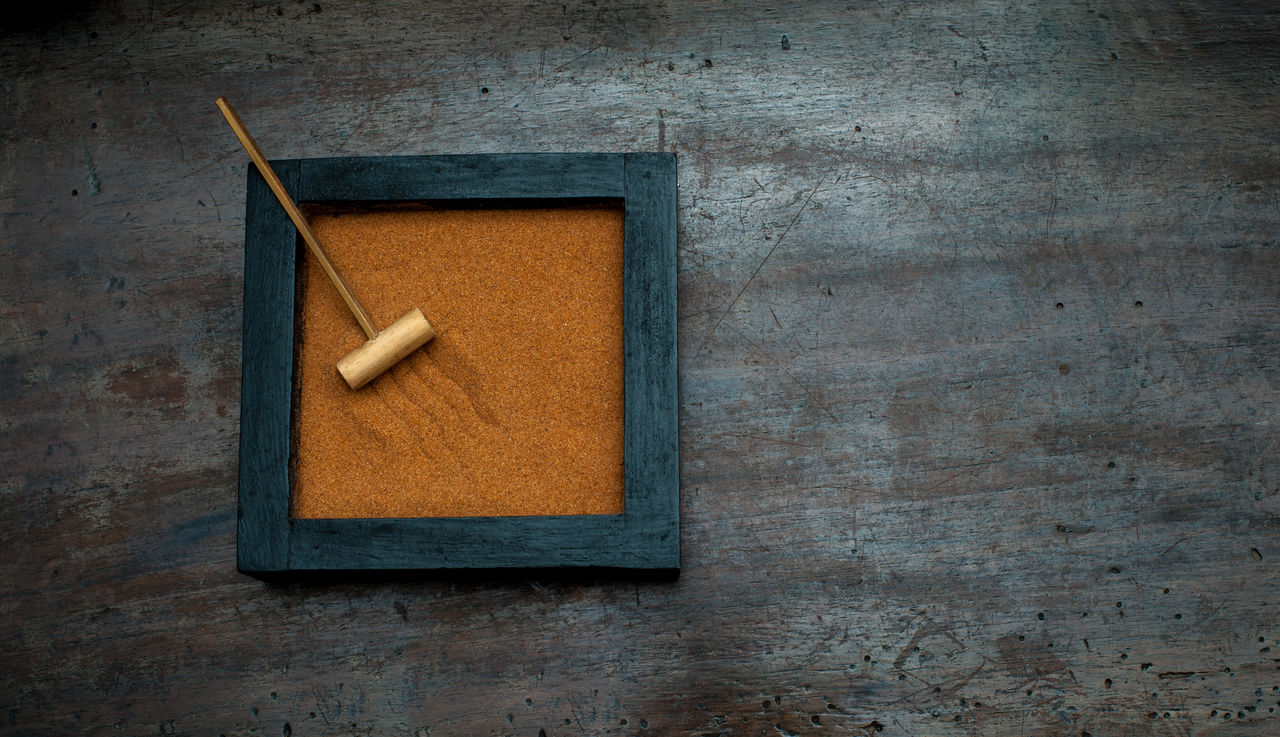 Brown zen garden on wooden table