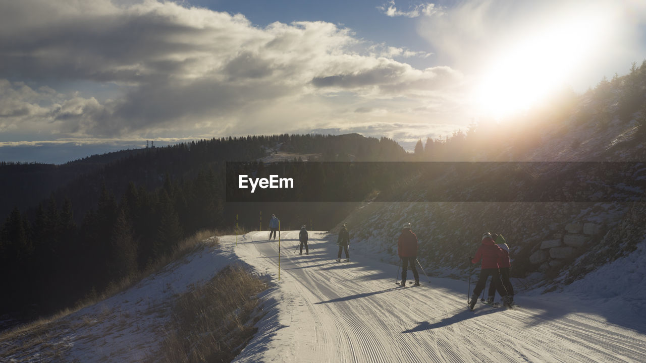 Tourist walking on snow covered landscape