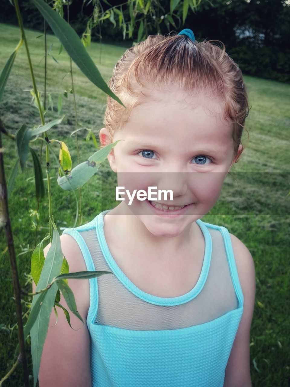 Portrait of smiling girl standing in park