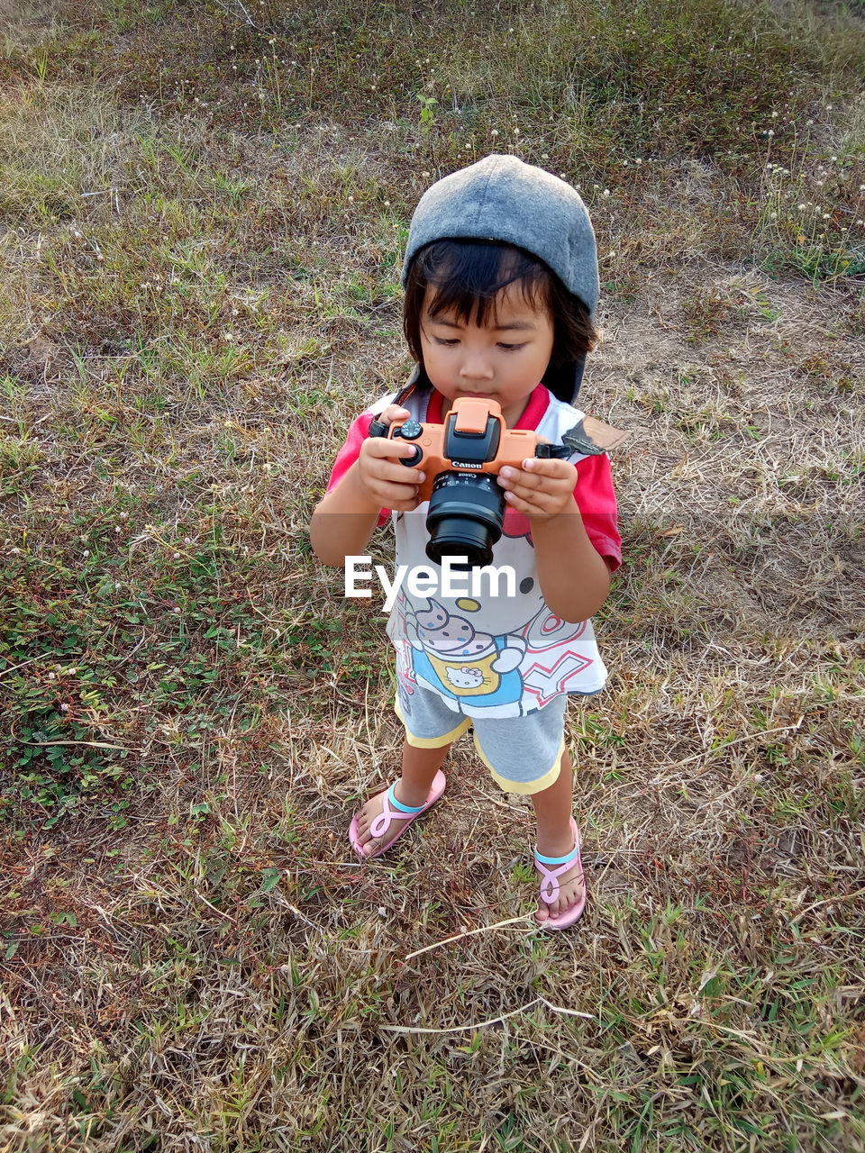 FULL LENGTH OF CUTE BABY GIRL IN FIELD