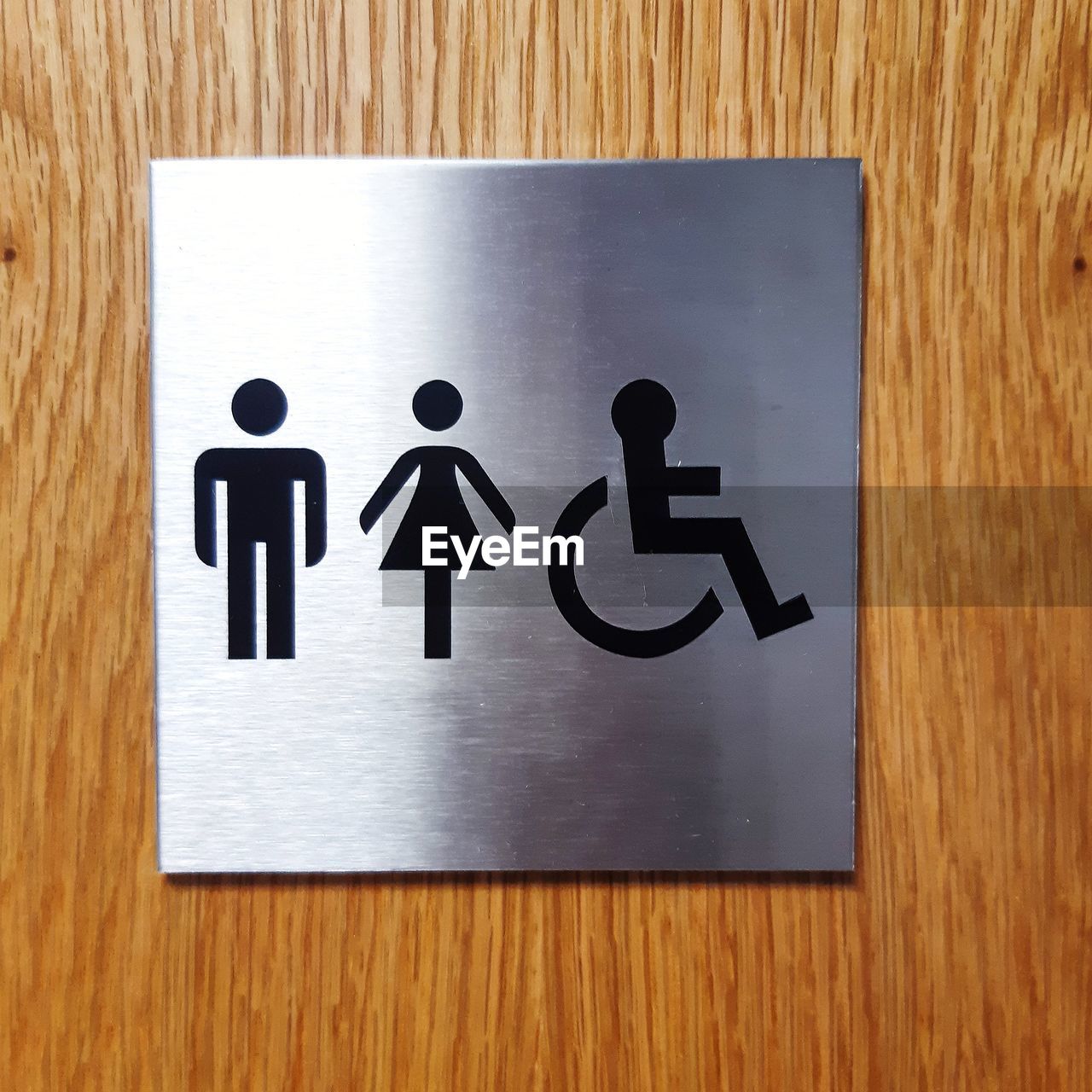 wood, communication, sign, human representation, indoors, font, restroom sign, public building, public restroom, representation, disabled access, differing abilities, no people, text, number, close-up, logo, symbol, disabled sign