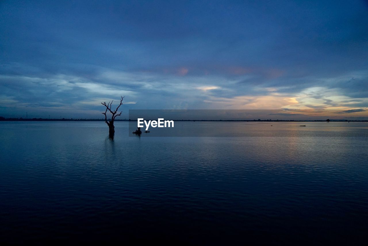 Scenic view of sea against cloudy sky