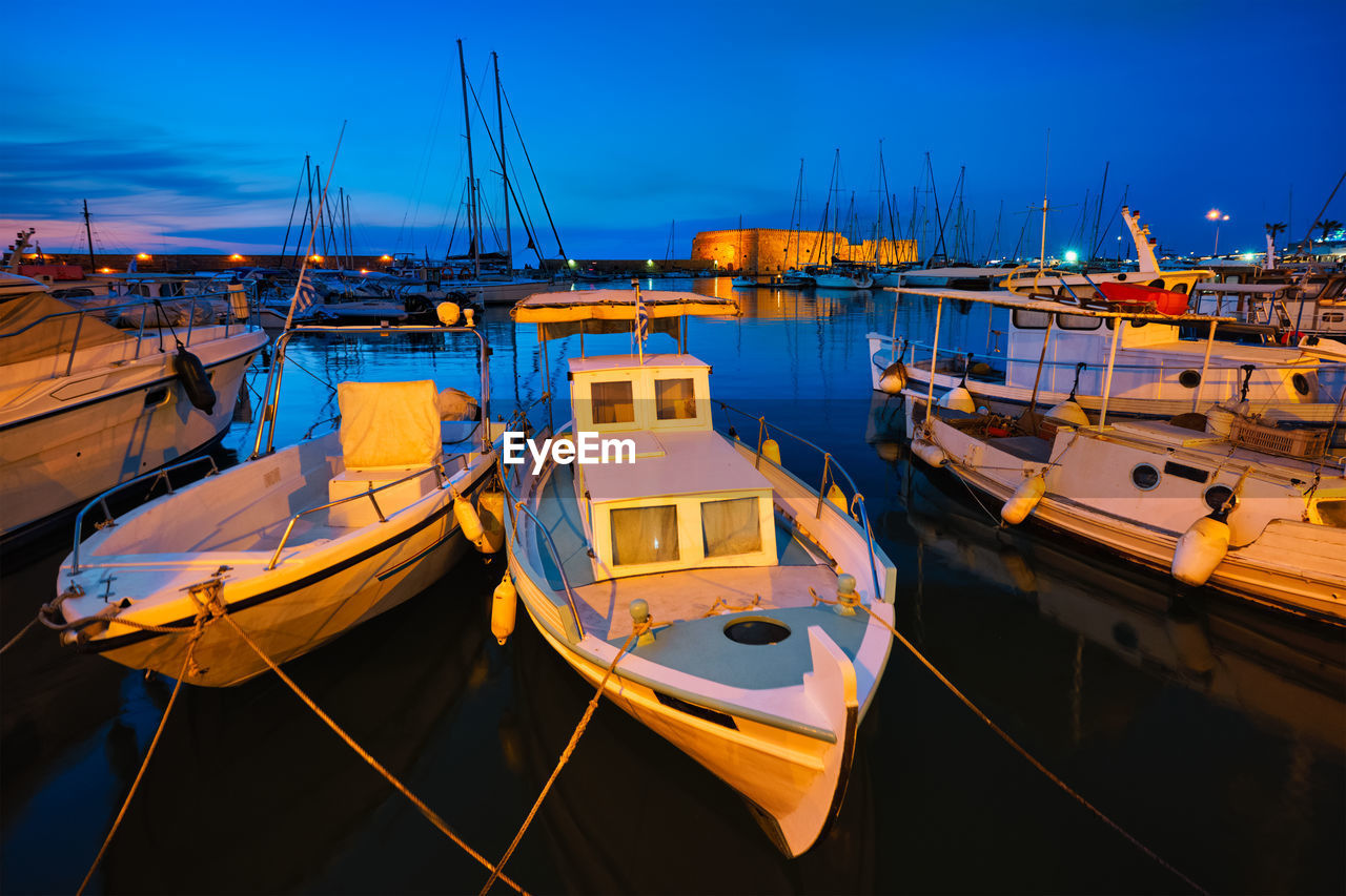 Venetian fort in heraklion and moored fishing boats, crete island, greece