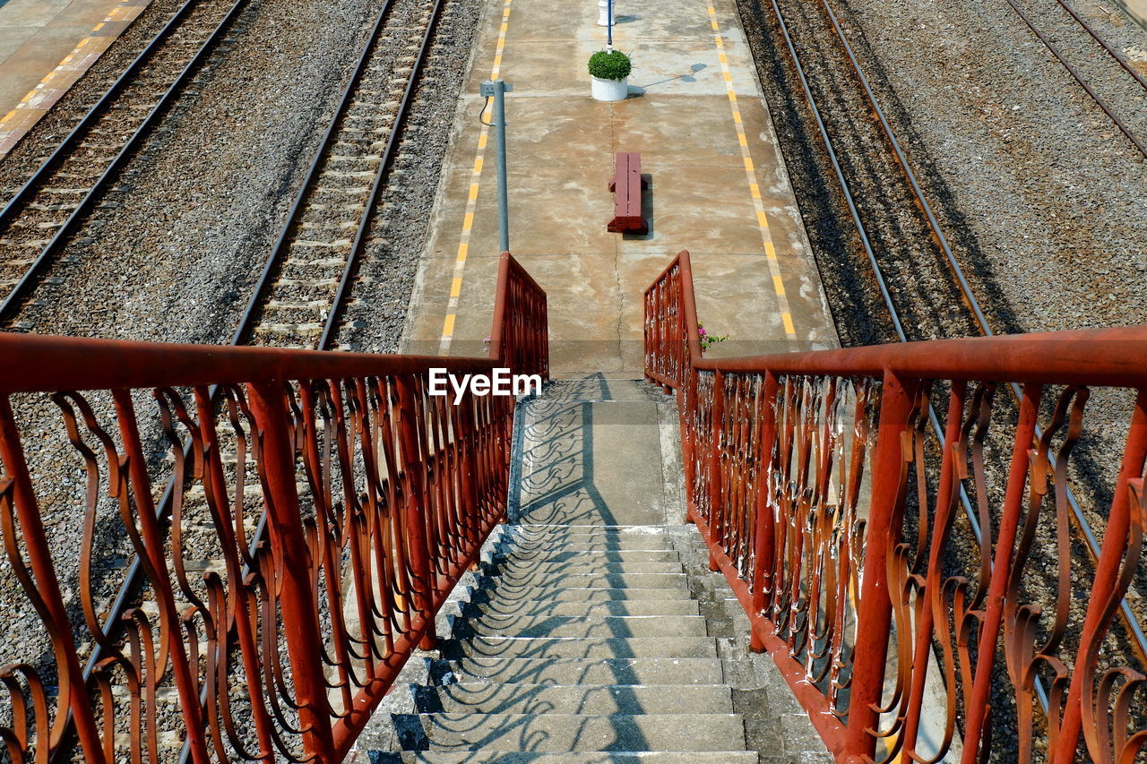 High angle view of footbridge over railroad tracks