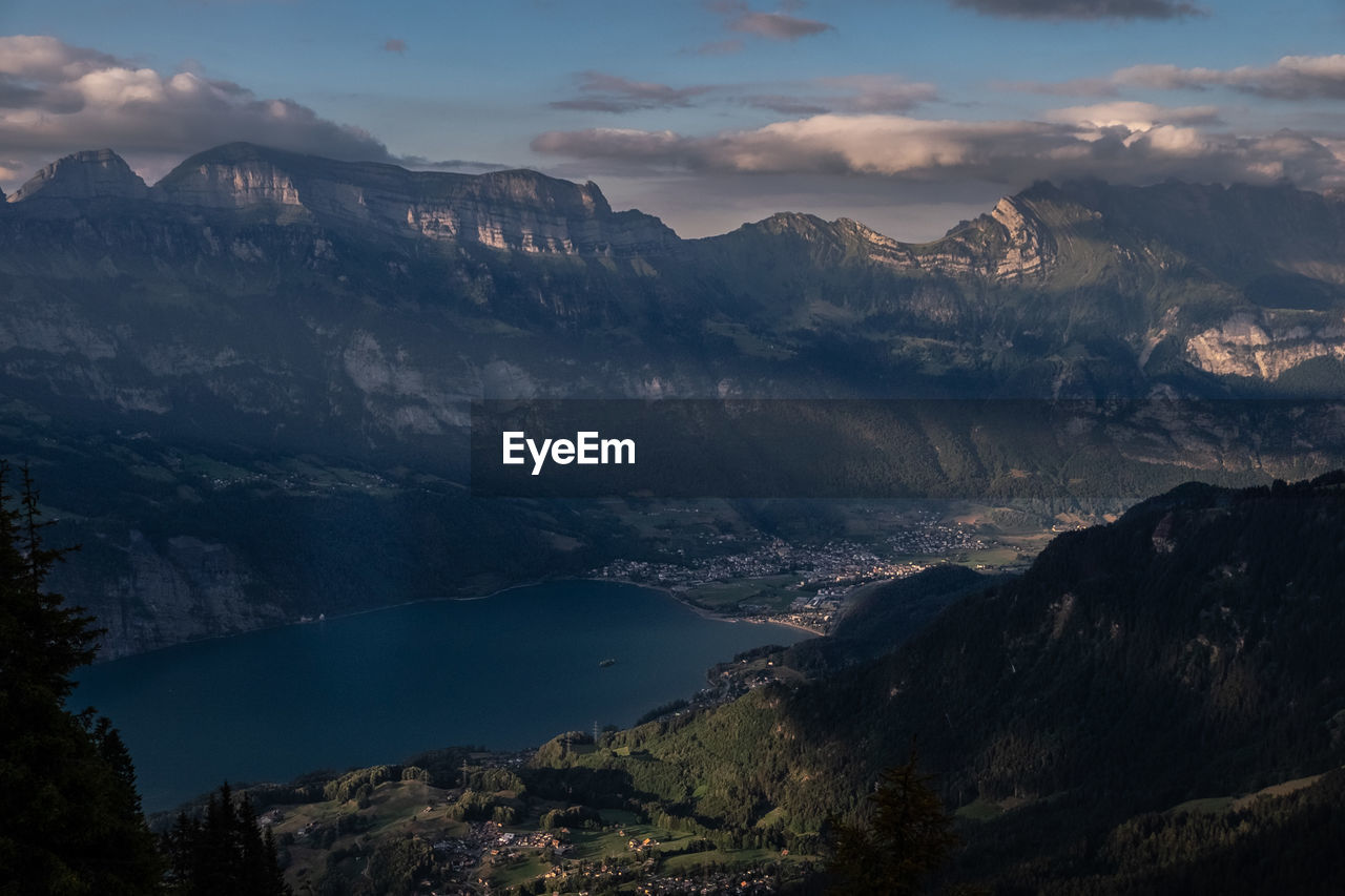 Scenic view of lake and mountains against sky