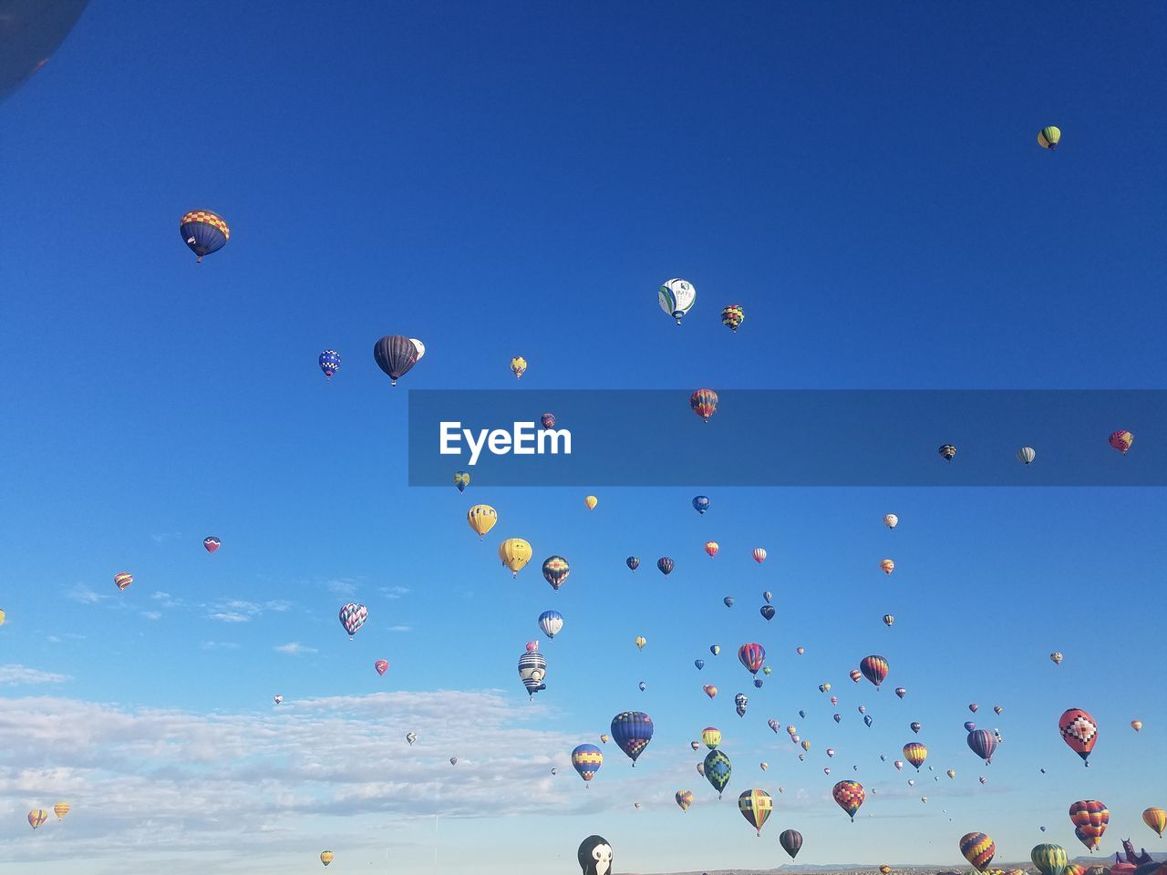 Low angle view of hot air balloons against blue sky