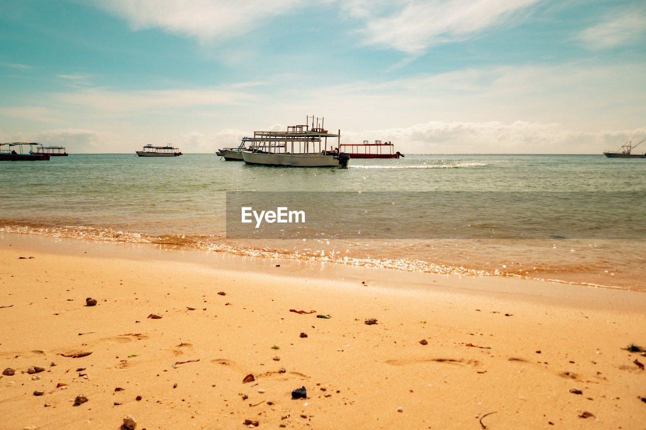 Scenic view of malindi beach with fishing boats at the background at sunrise in malindi, kenya