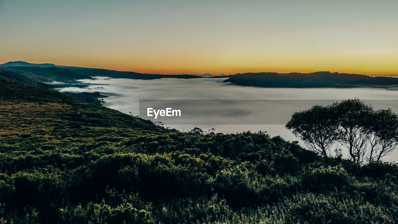 SCENIC VIEW OF LAND DURING SUNSET