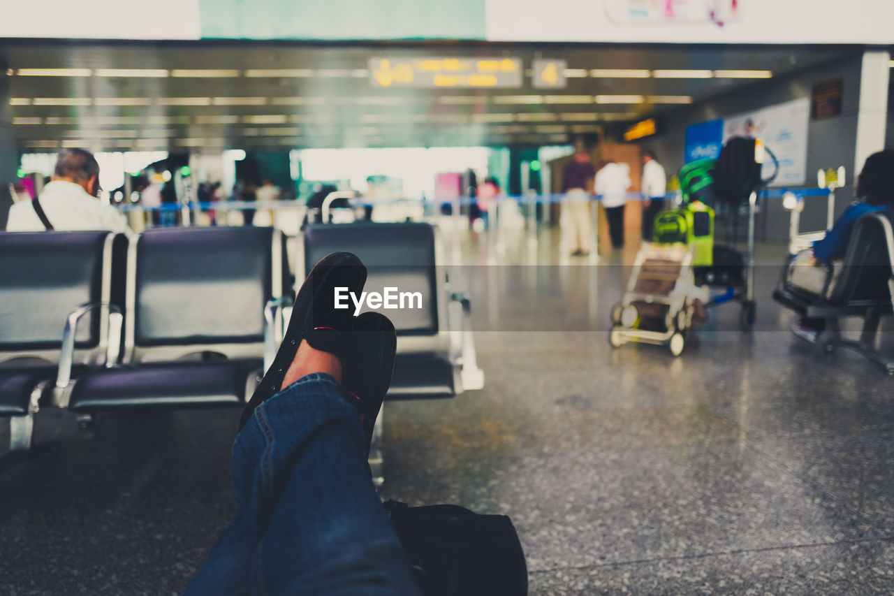 Low section of person resting at airport