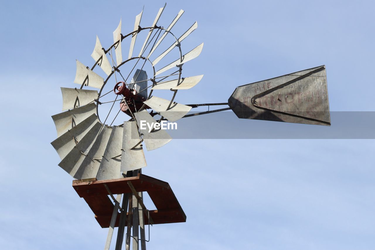 Low angle view of traditional windmill against sky