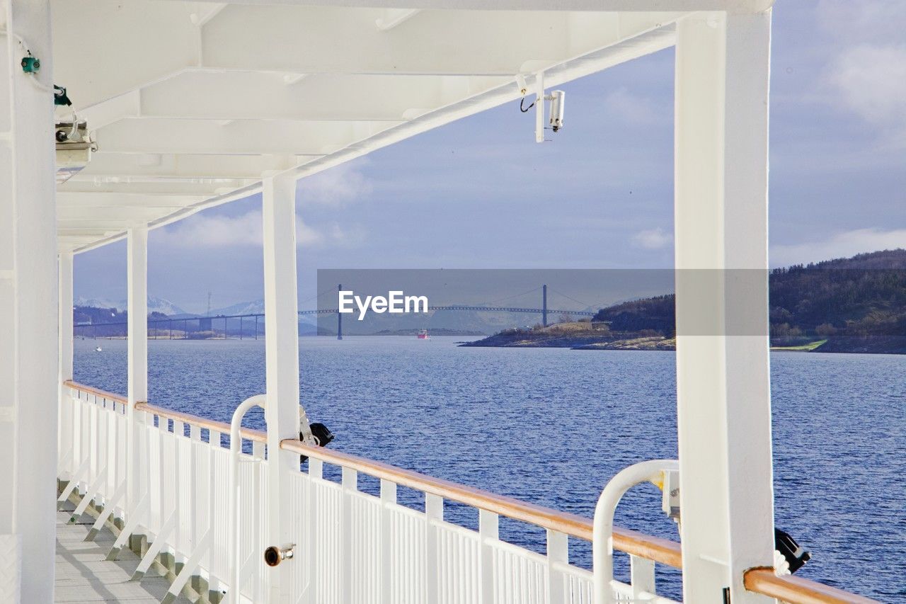 water, sea, passenger ship, architecture, nature, sky, transportation, scenics - nature, travel, ship, luxury, railing, day, vacation, nautical vessel, vehicle, beauty in nature, no people, built structure, outdoors, wealth, travel destinations, mode of transportation, tranquility, holiday, sunlight, window, tranquil scene, land, boat, blue, yacht, building exterior