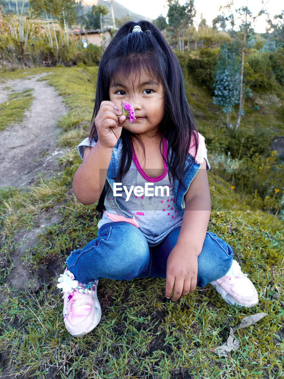 Portrait of a girl sitting on field