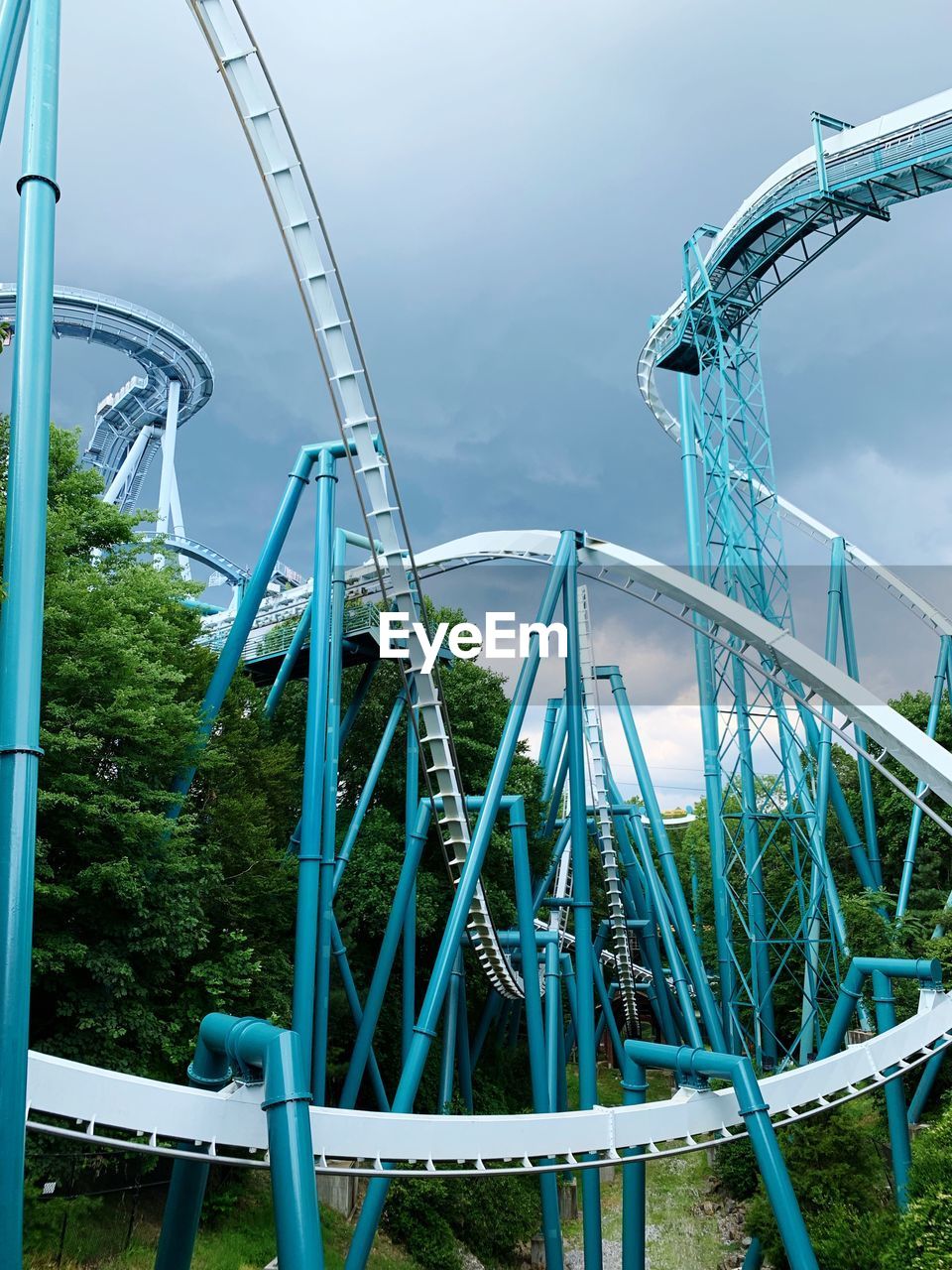 Low angle view of roller coaster ride against sky