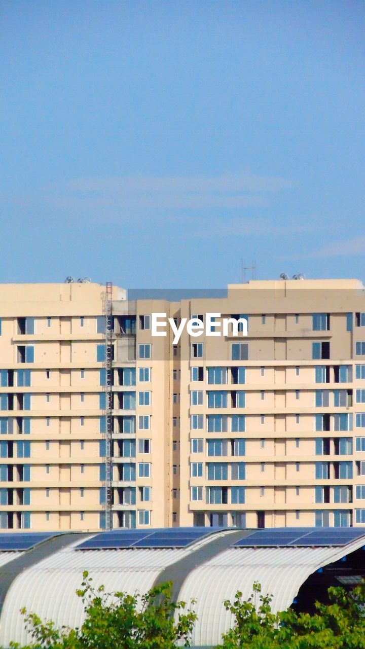 BUILDINGS AGAINST CLEAR BLUE SKY