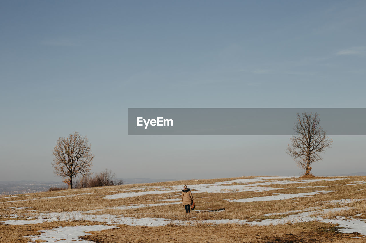 Scenic view of field against sky during winter