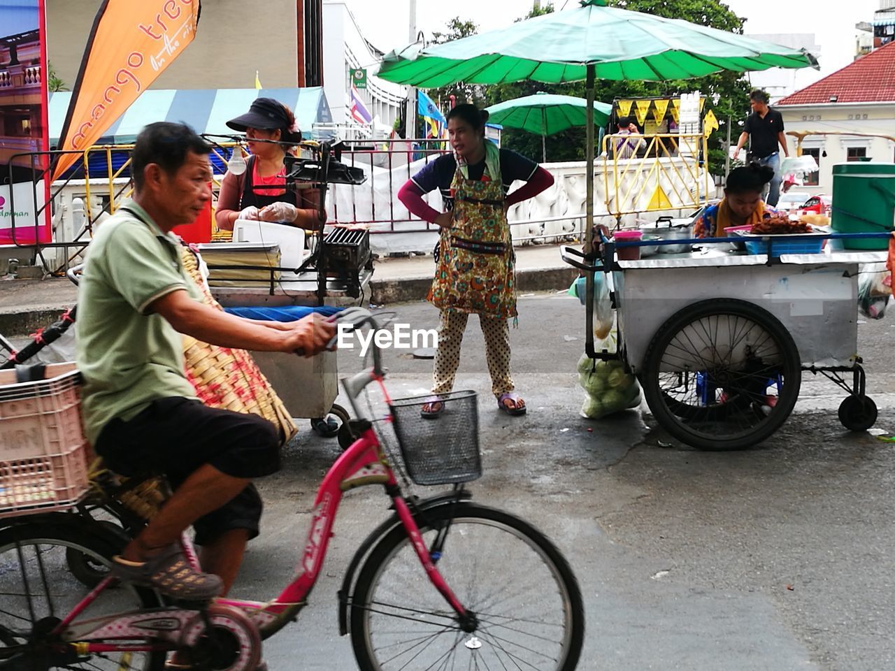 BICYCLE PARKED ON ROAD IN CITY