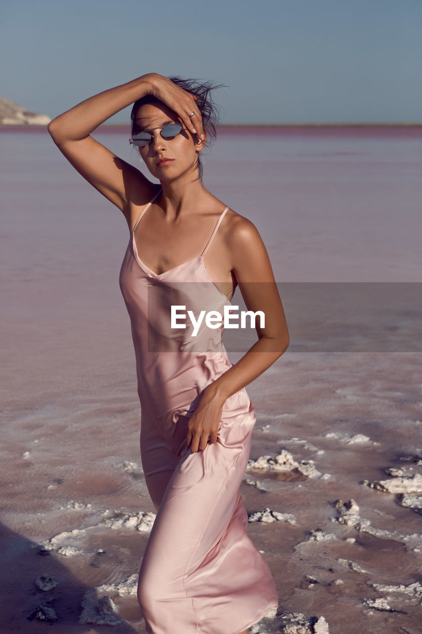 Woman on a dried up salt lake in a pink dress in the crimea